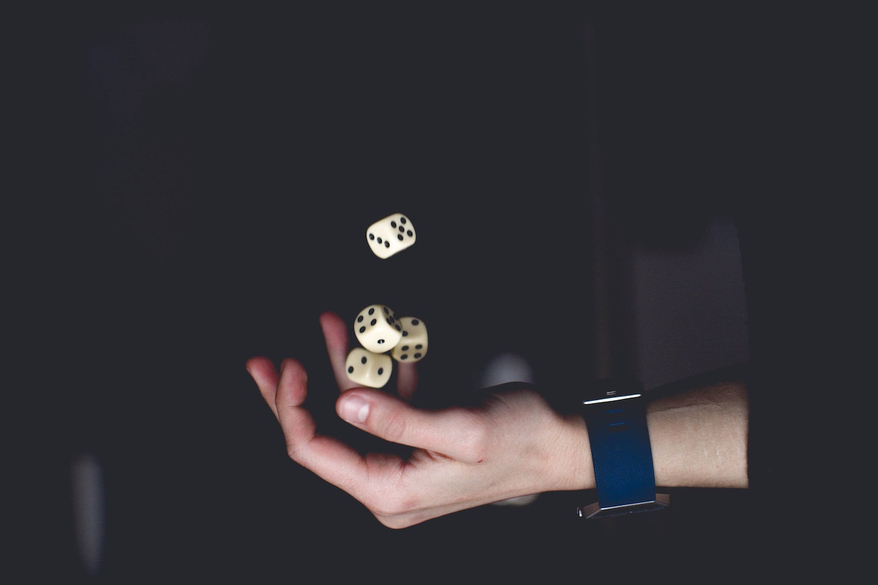 person rolling dices