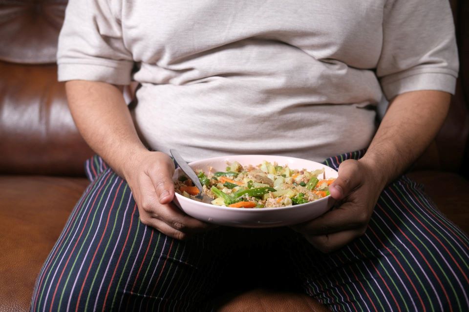 Person holding a bowl of food